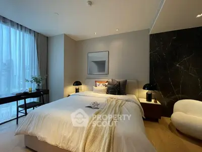 Luxurious modern bedroom with elegant decor and city view, featuring cozy lighting and stylish furnishings.