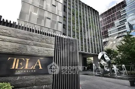 Modern luxury building entrance with sleek design and water feature in Thonglor.