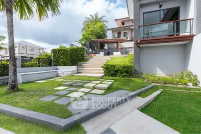 Modern home exterior with lush garden and stylish patio area