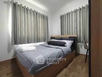 Cozy bedroom with modern decor and ample natural light