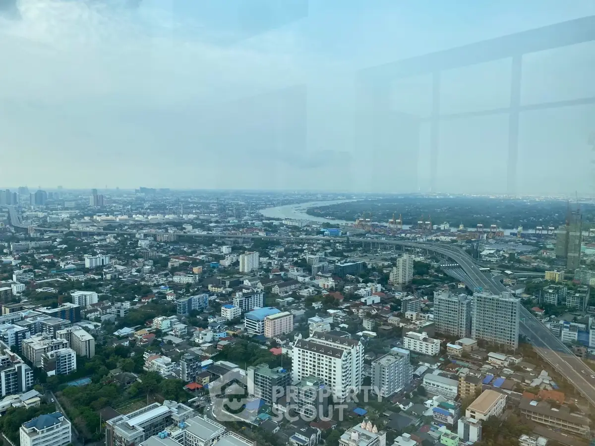 Stunning high-rise cityscape view showcasing urban skyline and river, perfect for luxury real estate listings.