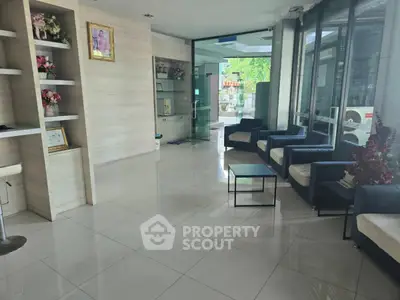 Spacious modern lobby with elegant seating and glass entrance, ideal for welcoming guests.