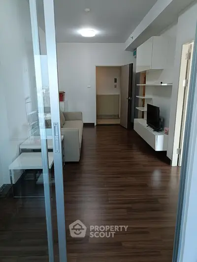 Modern living room with sleek wooden flooring and minimalist decor