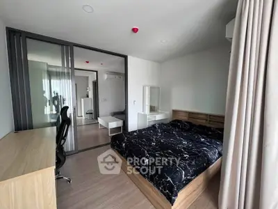 Modern bedroom with sleek design and workspace in a stylish apartment