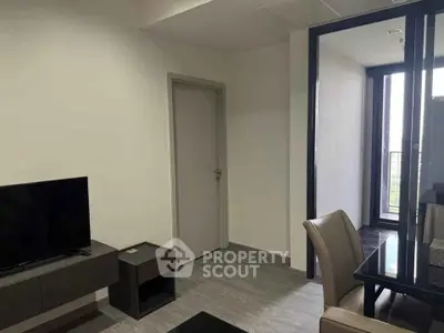 Modern apartment interior with sleek dining area and balcony view.