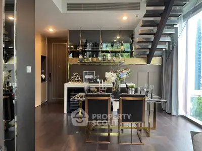 Luxurious modern dining area with elegant decor and open staircase in a high-rise apartment.