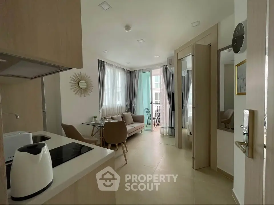 Modern open-plan living room with stylish decor and balcony access, perfect for urban living.