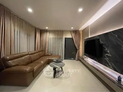 Luxurious modern living room with leather sofa and sleek TV setup
