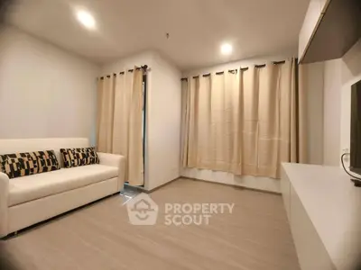 Modern living room with sleek flooring and stylish curtains, featuring a comfortable white sofa.