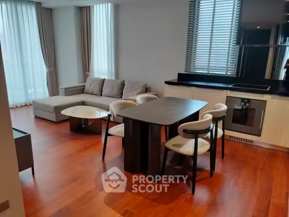 Modern living room with elegant dining area and stylish furniture in a spacious apartment.