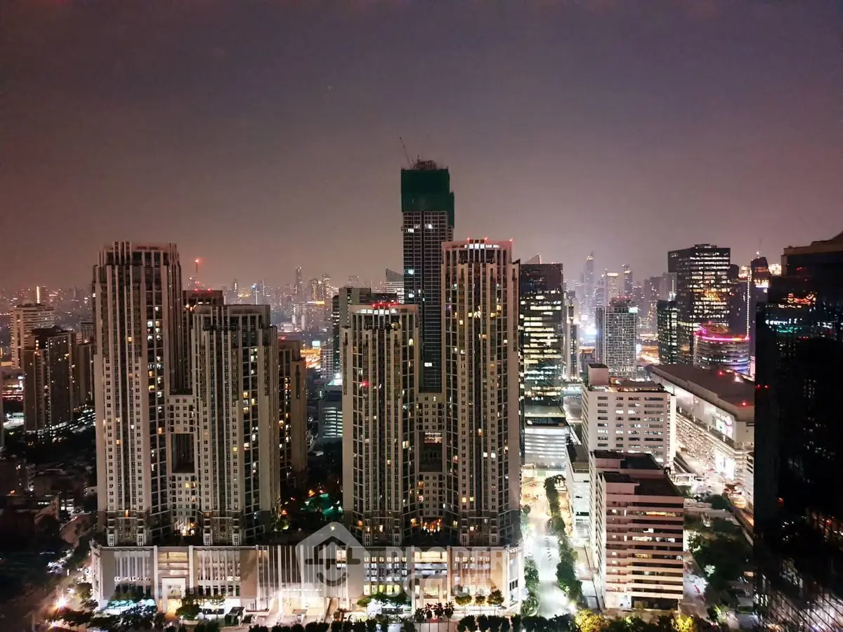 Stunning cityscape view of illuminated skyscrapers at night, showcasing urban living.