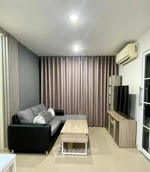 Modern living room with sleek furniture and large TV, perfect for relaxation.