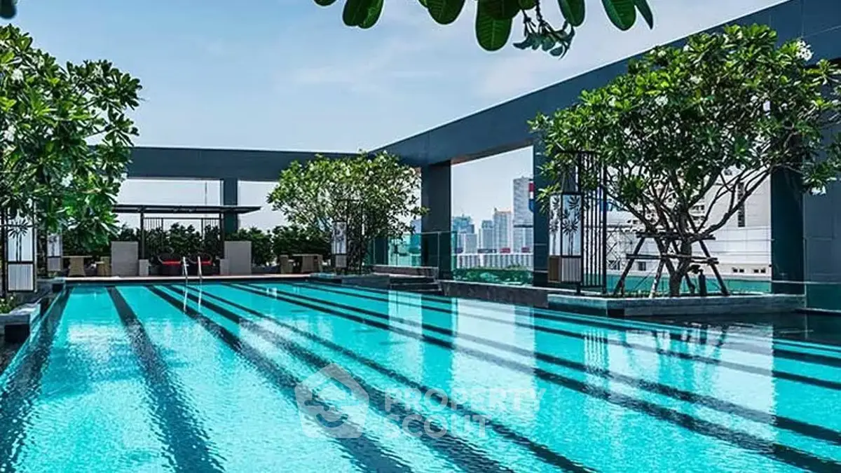 Luxurious rooftop pool with city skyline views and lush greenery, perfect for relaxation and leisure.