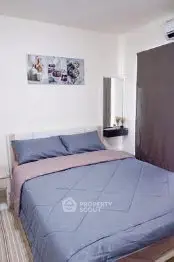 Cozy bedroom with modern decor and comfortable bedding in a stylish apartment.
