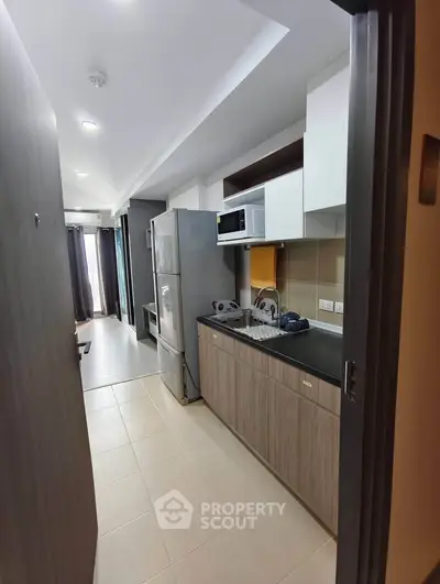 Modern kitchen with sleek cabinetry and appliances in a stylish apartment