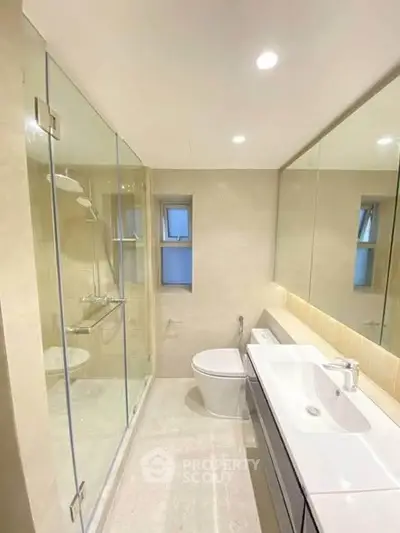 Modern bathroom with glass shower and sleek fixtures
