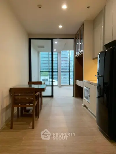 Modern kitchen with sleek appliances and dining area in a stylish apartment