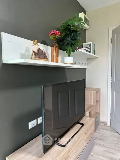 Modern living room with sleek TV setup and stylish shelving