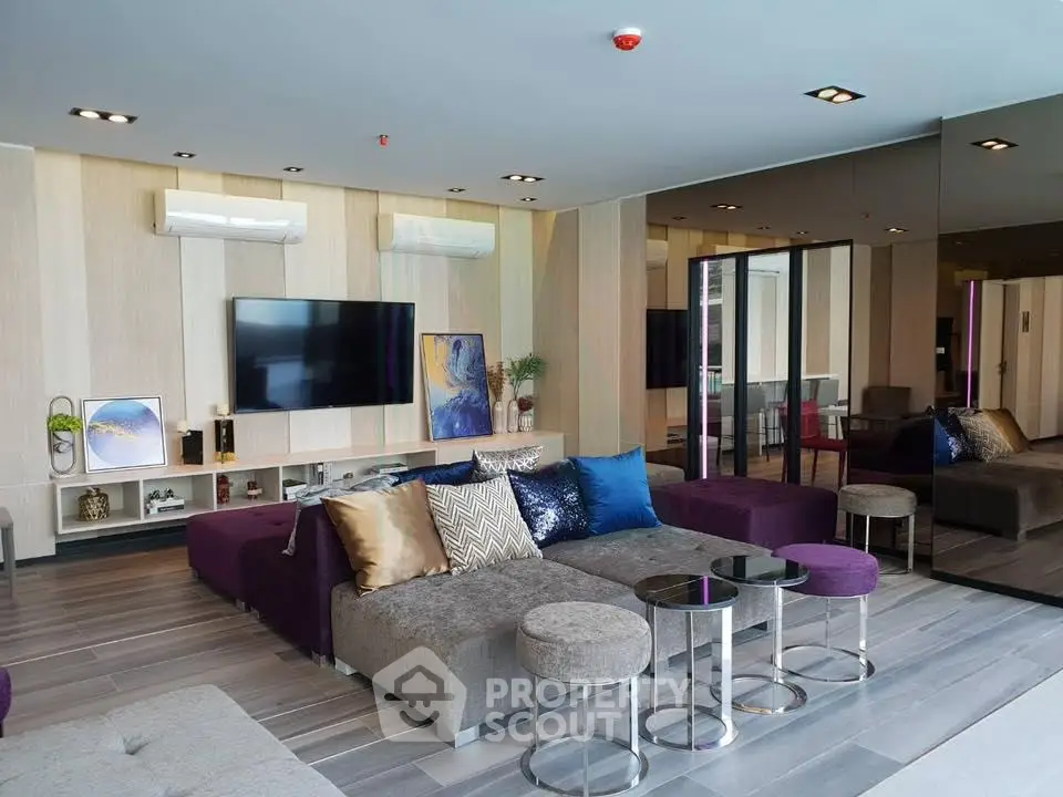 Luxurious modern living room with stylish decor and plush seating in a contemporary apartment.