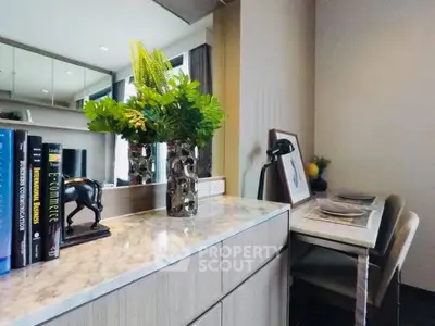 Modern study area with elegant decor and natural light in a stylish apartment.