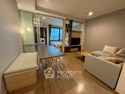 Modern open-plan living room with dining area and city view