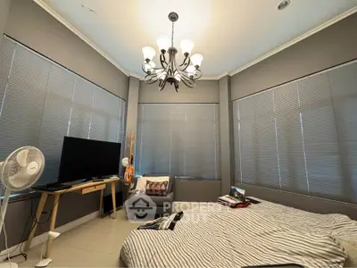 Spacious bedroom with modern decor and large windows