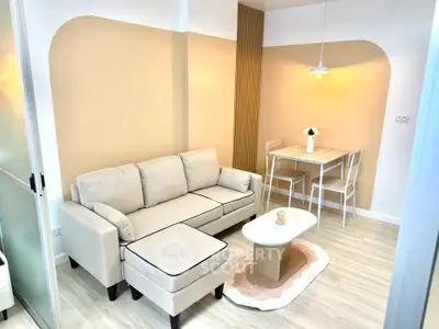 Modern living room with beige sofa and dining area in stylish apartment