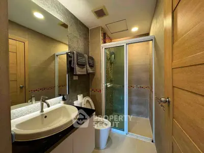 Modern bathroom with sleek design, glass shower, and stylish fixtures in a contemporary home.