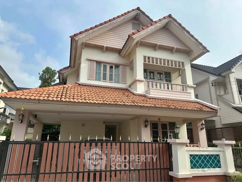 Charming two-story house with red-tiled roof and spacious front yard in a serene neighborhood.