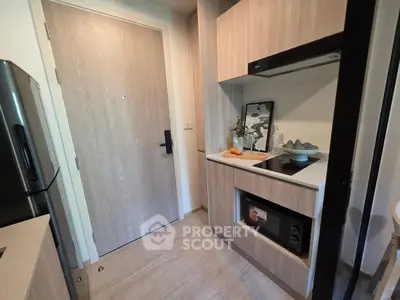 Modern kitchen with sleek appliances and stylish cabinetry in a compact layout.