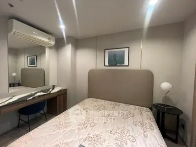 Modern bedroom with stylish decor and air conditioning, featuring a cozy bed and elegant furnishings.