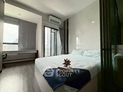 Modern bedroom with city view and stylish decor in high-rise apartment