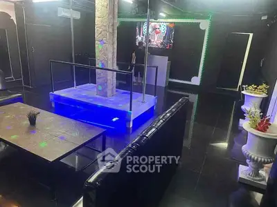 Luxurious entertainment room with modern lighting and sleek black decor