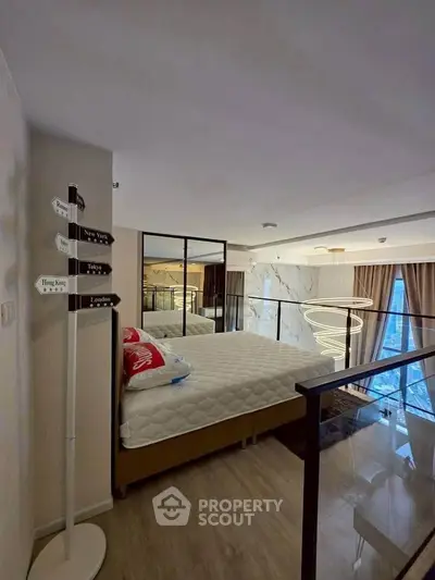 Modern loft bedroom with stylish decor and city view, featuring a cozy bed and elegant lighting.