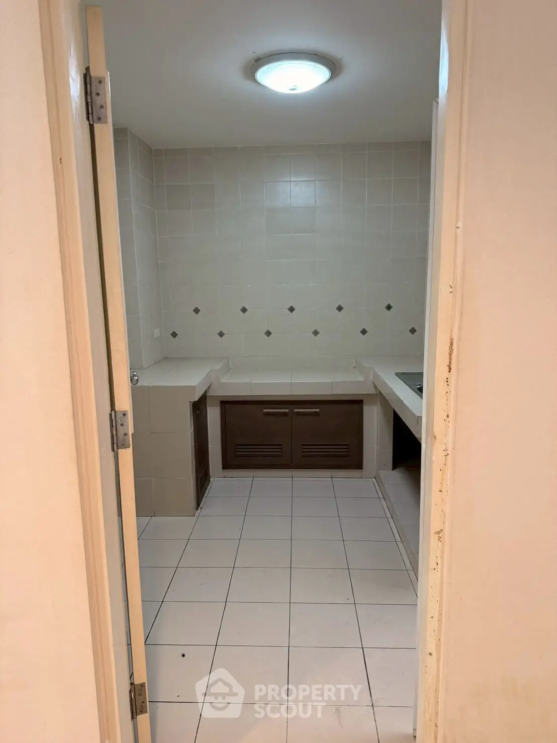 Spacious bathroom with tiled walls and built-in cabinets