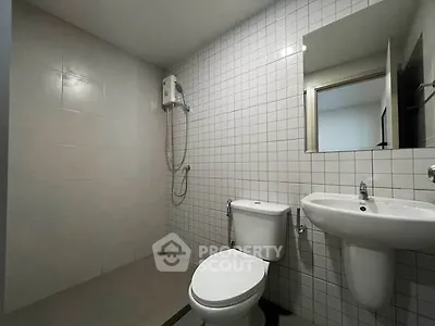 Modern minimalist bathroom with white tiles and sleek fixtures