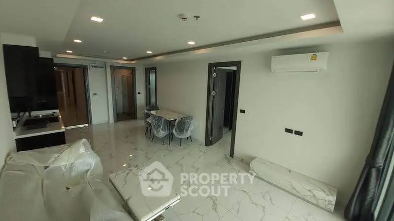 Modern living room with sleek design and marble flooring in a contemporary apartment.