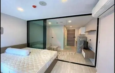 Modern bedroom with glass partition and air conditioning in a stylish apartment.