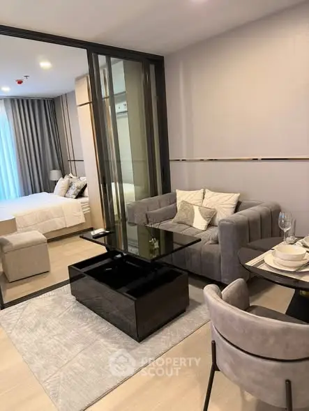 Modern living room with elegant decor and cozy bedroom view