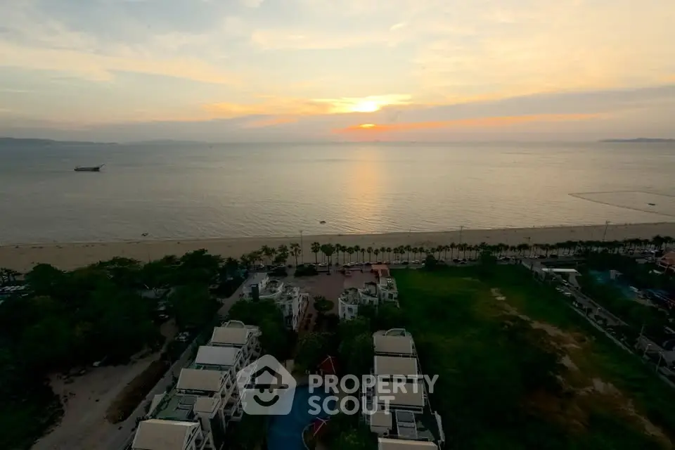 Stunning ocean view from high-rise building at sunset, ideal for luxury living.