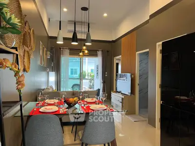Modern dining and living area with stylish decor and natural light