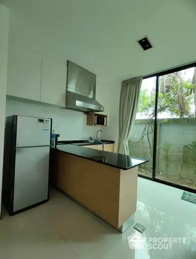 Modern kitchen with sleek design and large window view