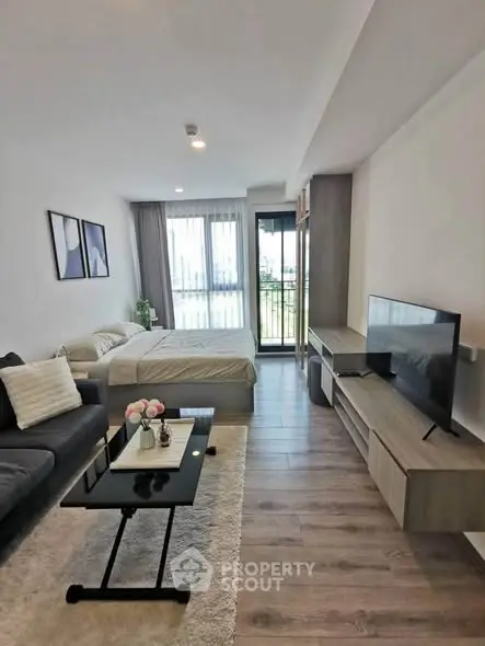 Modern studio apartment with stylish decor and balcony view