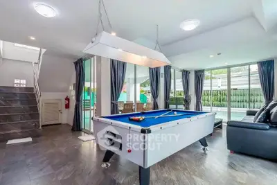 Luxurious living room with pool table and modern decor, perfect for entertainment and relaxation.