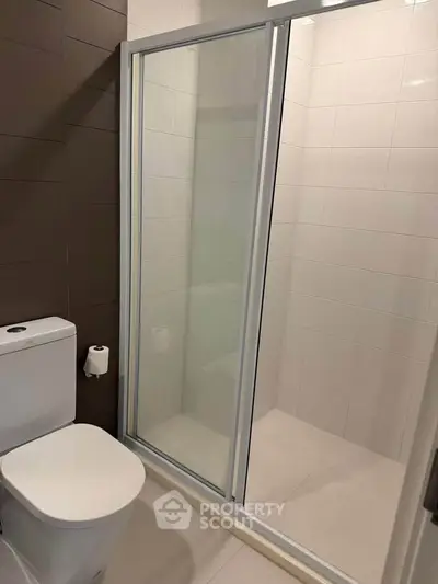 Modern bathroom with sleek shower enclosure and contemporary toilet design.