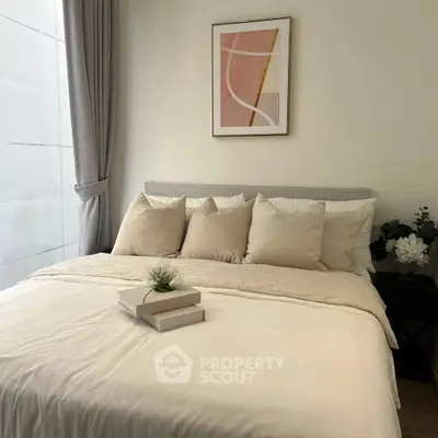 Cozy bedroom with modern decor and soft lighting, featuring a stylish bed and elegant wall art.