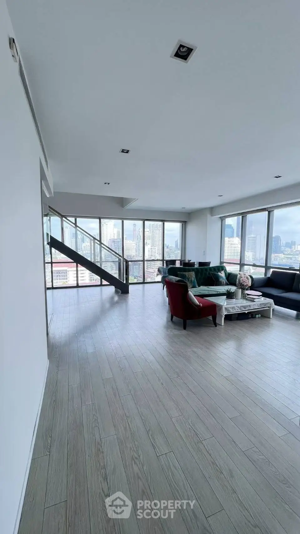 Spacious modern living room with panoramic city views and stylish furniture