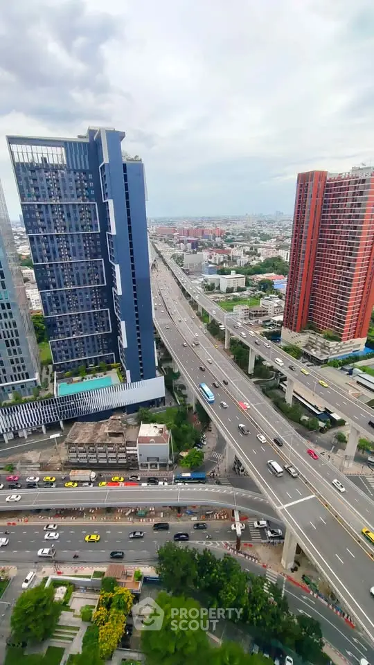 Stunning cityscape view from high-rise building showcasing urban skyline and bustling highway.