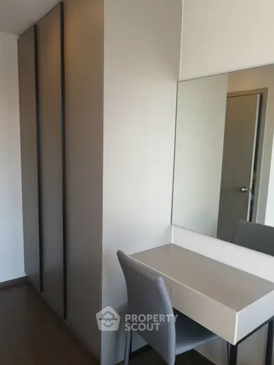 Modern bedroom with sleek wardrobe and stylish vanity desk