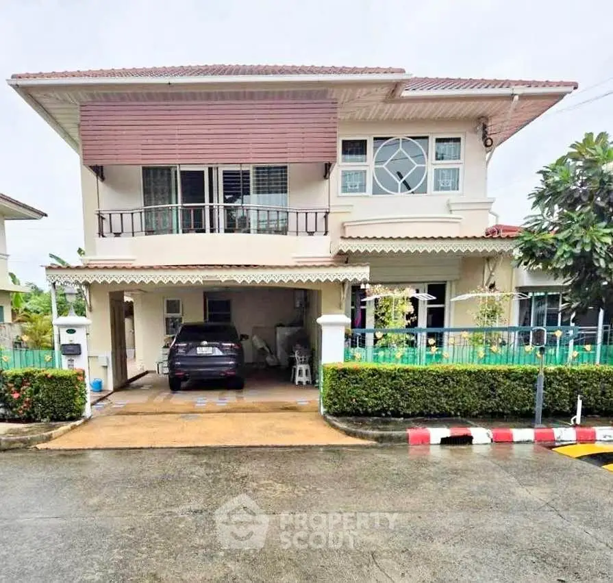 Charming two-story house with carport and lush garden in a serene neighborhood.